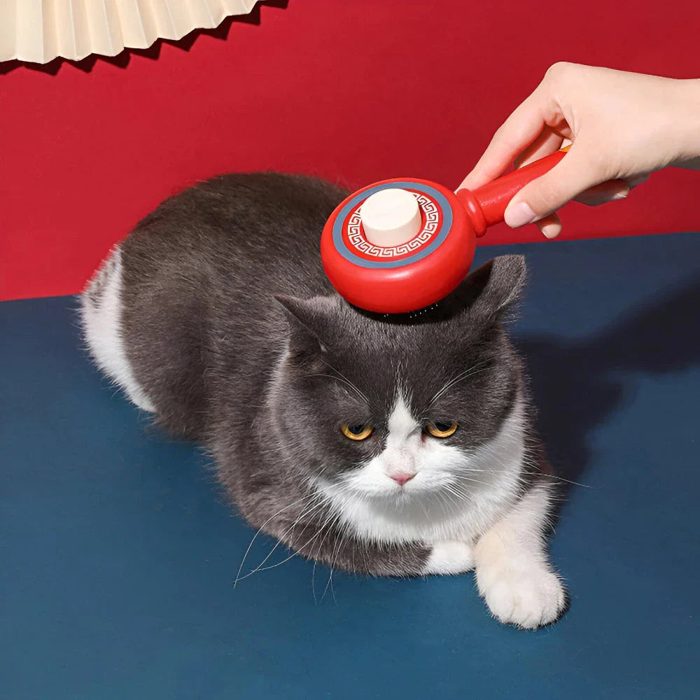 One-Click Pet Hair Removal Comb in red colour, designed to effectively remove loose fur and tangles from cat or dog coats