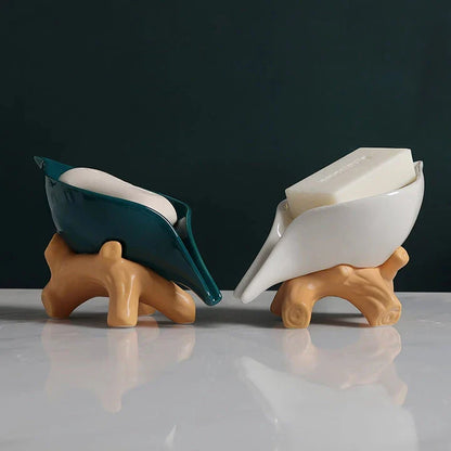 Elegant ceramic leaf-shaped soap holder with a sturdy base, adding a touch of nature-inspired sophistication to any bathroom