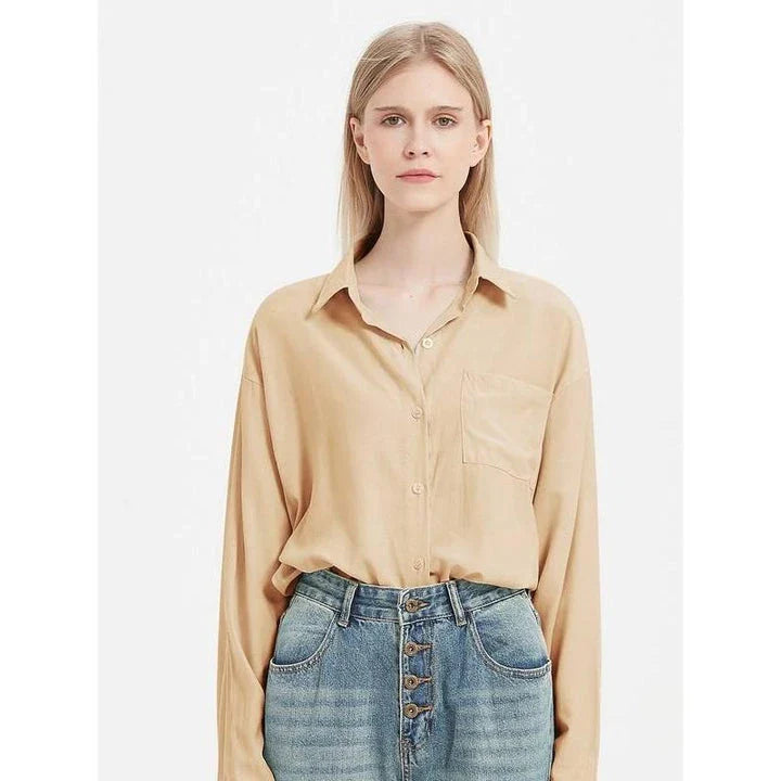 A classic long-sleeve button-up blouse in a range of chic colours, offering timeless elegance and modern sophistication for the fashion-conscious woman.
