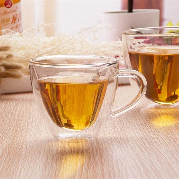 A charming heart-shaped ceramic mug with a smooth, glossy finish, perfect for enjoying hot beverages like tea or coffee.