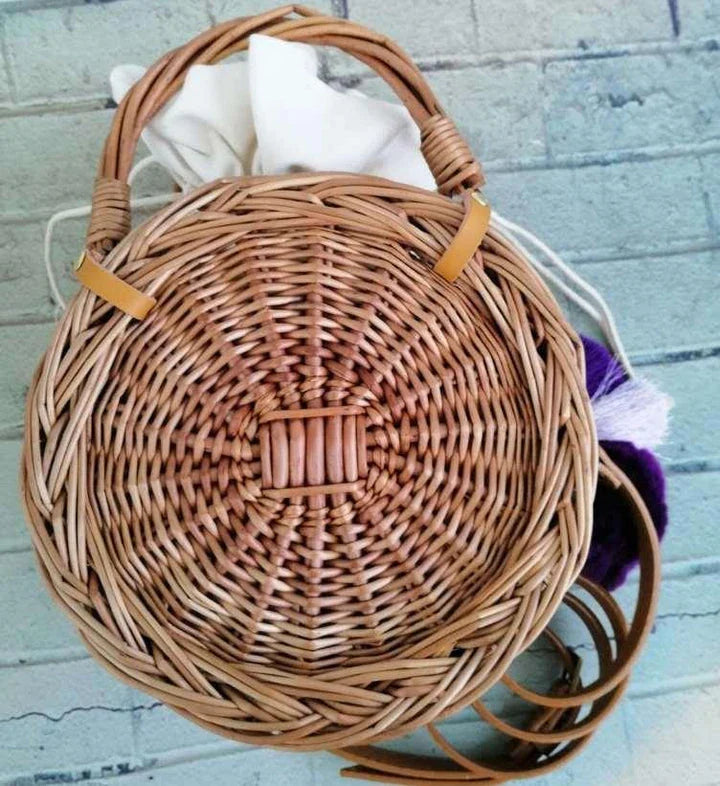 Charming floral hanging basket made of premium rattan, featuring a delicate flower pattern and versatile design for indoor or outdoor use.
