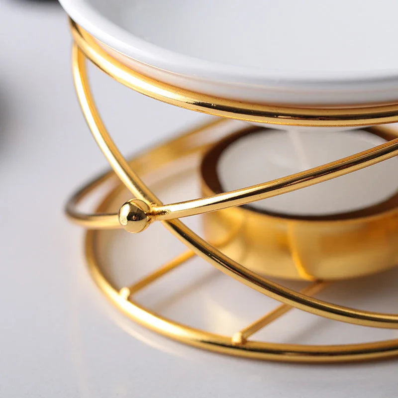 Elegant gold aromatherapy oil burner with a unique hollow-out design, creating a soothing and sophisticated ambiance in a living space