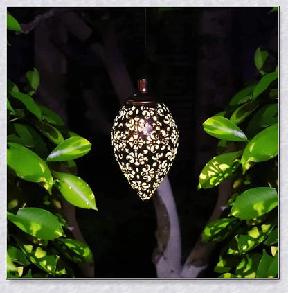 Decorative outdoor solar lanterns hanging in a lush garden, providing warm, ambient lighting