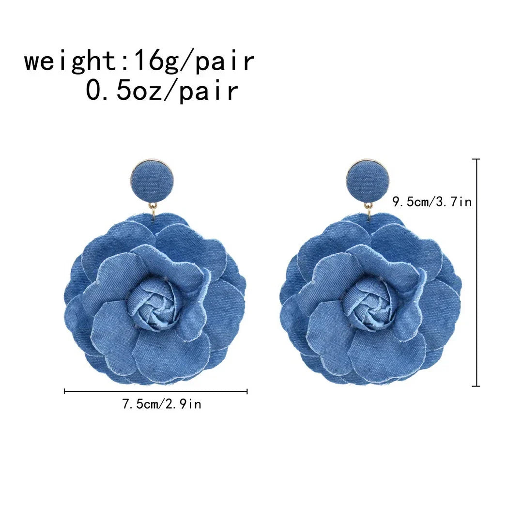 Elegant denim drop earrings with intricate details, a versatile accessory that adds a touch of refined British style to any outfit.