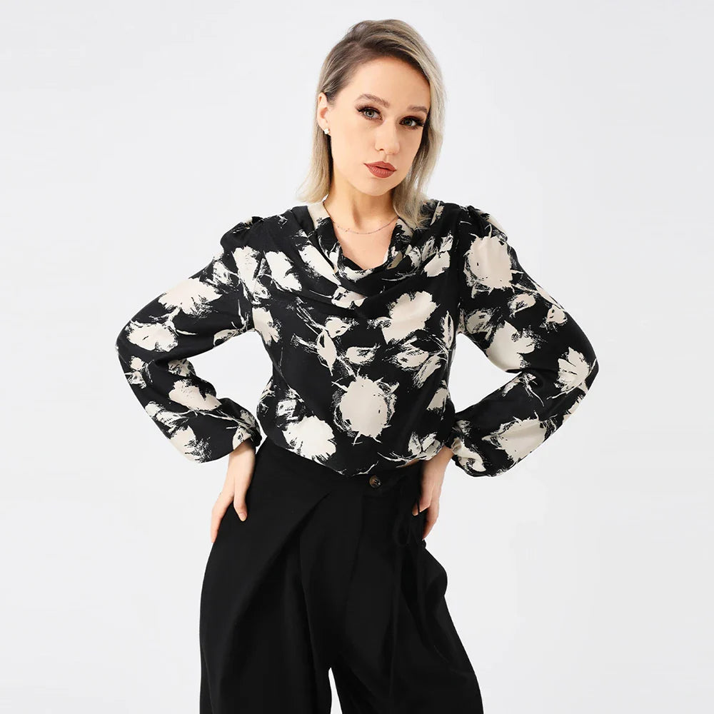 Elegant ladies' blouse with a printed pattern, dropped collar, and long sleeves in a classic white colour
