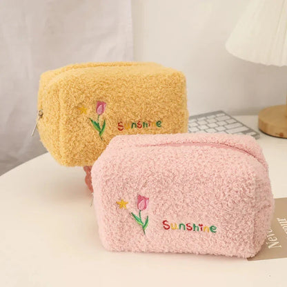 Elegant embroidered flowers cosmetic pouch made of soft, plush material in ivory colour