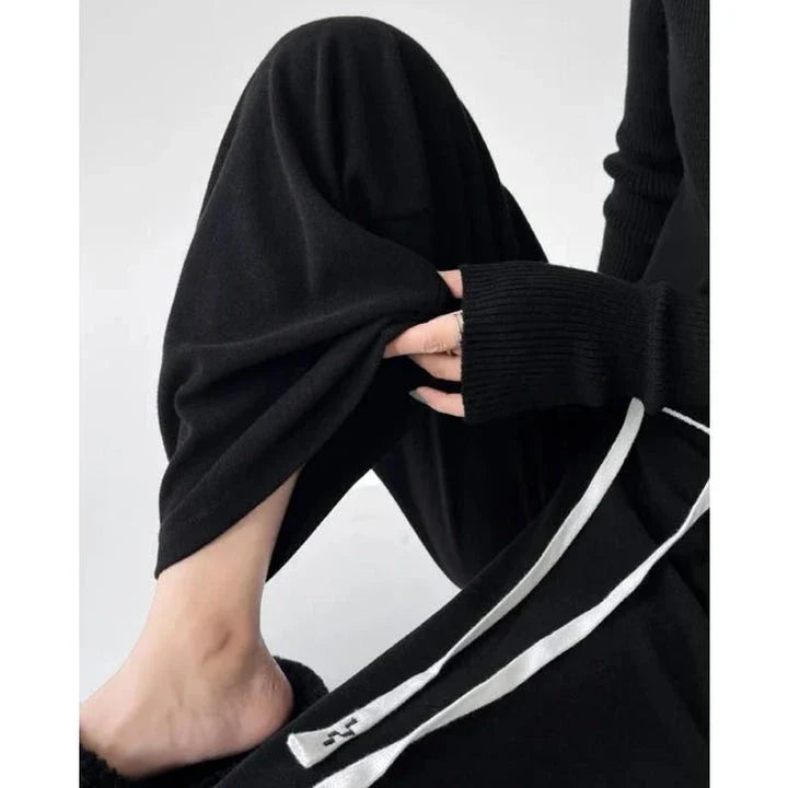 Elegant high-waist drawstring trousers in black, featuring a wide-leg cut and stylish lace-up pockets