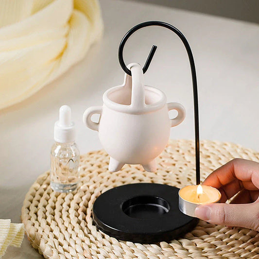 Captivating iron frame essential oil diffuser and candle holder with a unique witch's soup cup design
