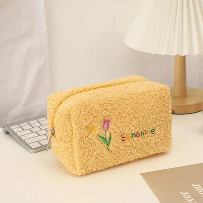Elegant embroidered flowers cosmetic pouch made of soft, plush material in ivory colour