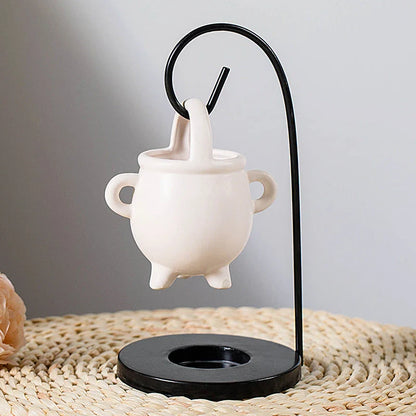 Captivating iron frame essential oil diffuser and candle holder with a unique witch's soup cup design