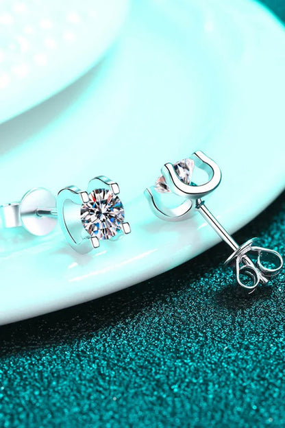 Pair of elegant 1 carat moissanite stud earrings in a minimalist silver setting, perfect for everyday wear or special occasions.
