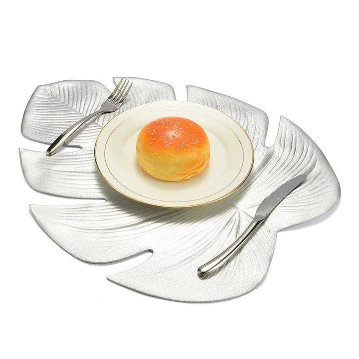 Elegant floral-patterned PVC dining table coaster in a contemporary setting, protecting a wooden table surface