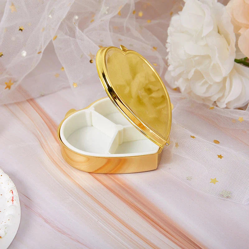 Heart-shaped metal pill box with built-in mirror for convenient storage and touch-ups on the go
