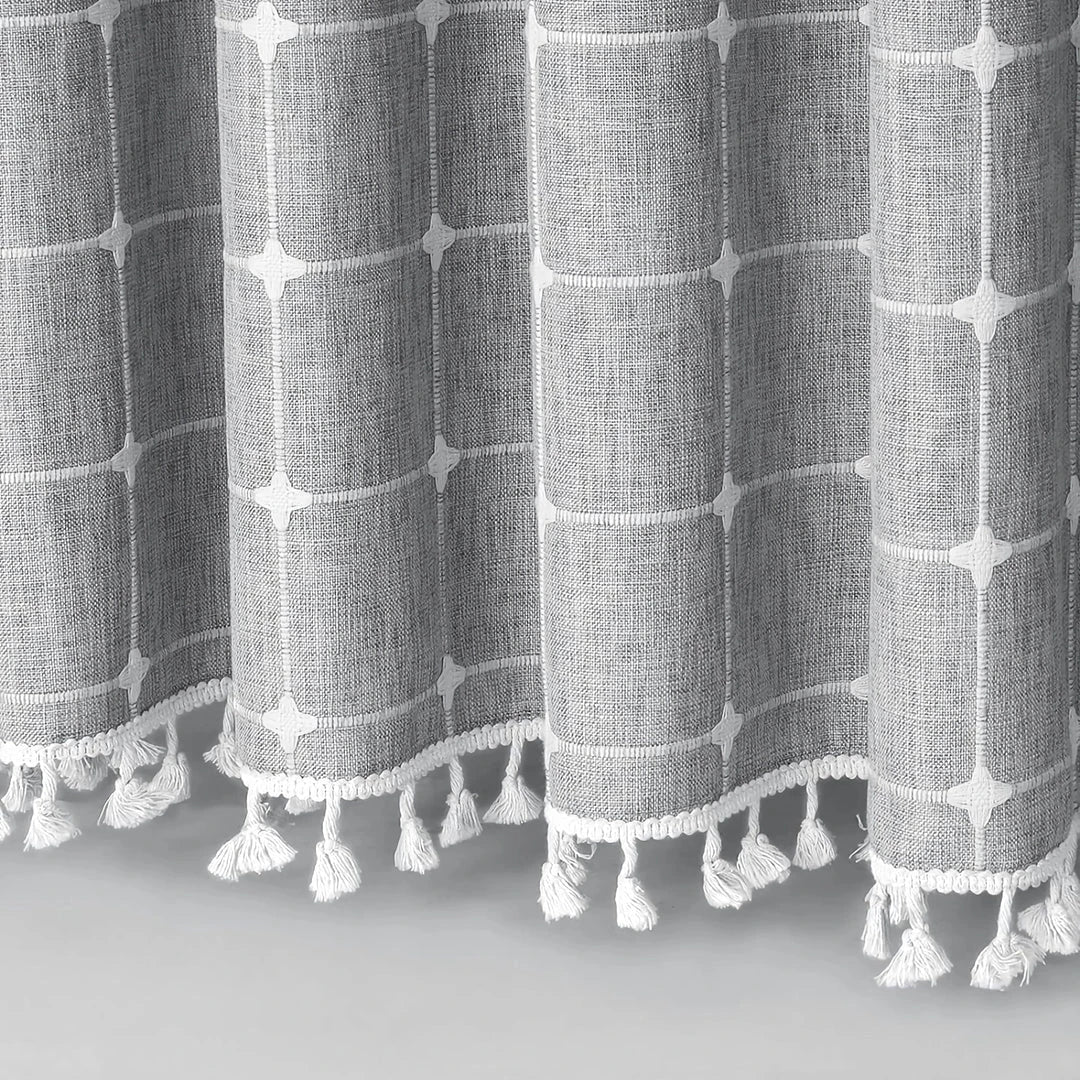 Elegant jacquard linen shower curtain with a geometric pattern and charming tassel accents, available in multiple sizes and colours for a premium bathroom upgrade.