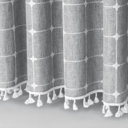 Elegant jacquard linen shower curtain with a geometric pattern and charming tassel accents, available in multiple sizes and colours for a premium bathroom upgrade.
