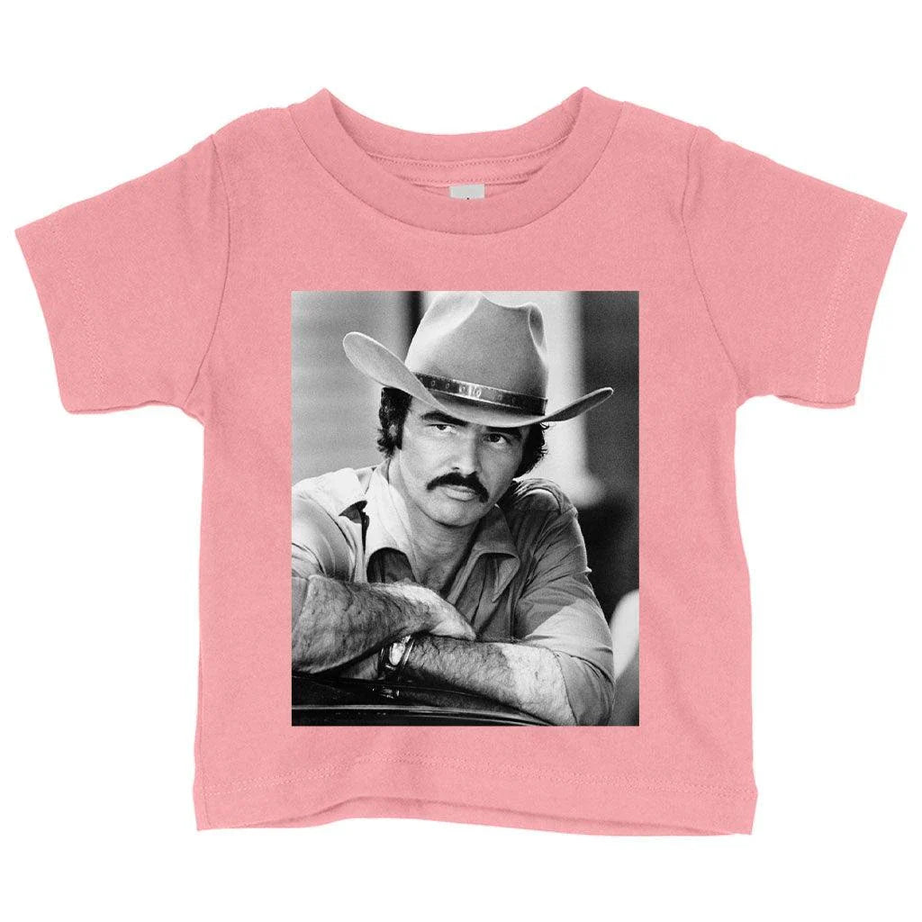 A vintage-inspired baby t-shirt featuring the iconic Burt Reynolds design, made with soft and breathable Airlume cotton.