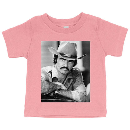 A vintage-inspired baby t-shirt featuring the iconic Burt Reynolds design, made with soft and breathable Airlume cotton.