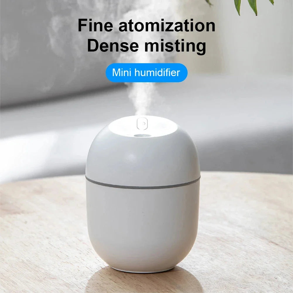 Compact ultrasonic humidifier and aroma diffuser with LED night light, designed for use in home or office spaces.