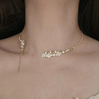 Elegant handcrafted clavicle necklace made of natural pearl shell with an intricate floral pattern, a timeless British design accessory.