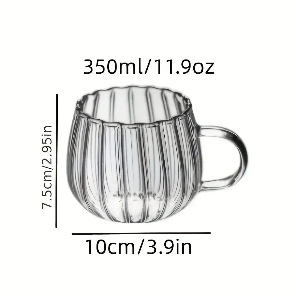 A set of heat-resistant glass mugs featuring a charming pumpkin pattern design, perfect for cosy UK mornings.