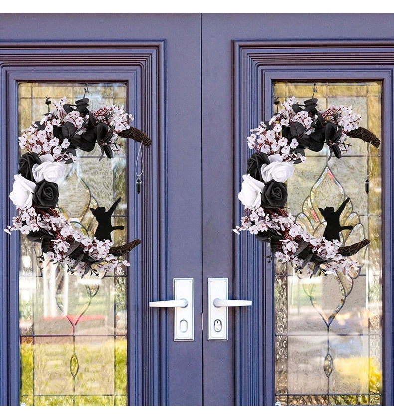 Spooktacular Halloween garland featuring a blend of dried white flowers, black roses, and mystical moon cat ornaments