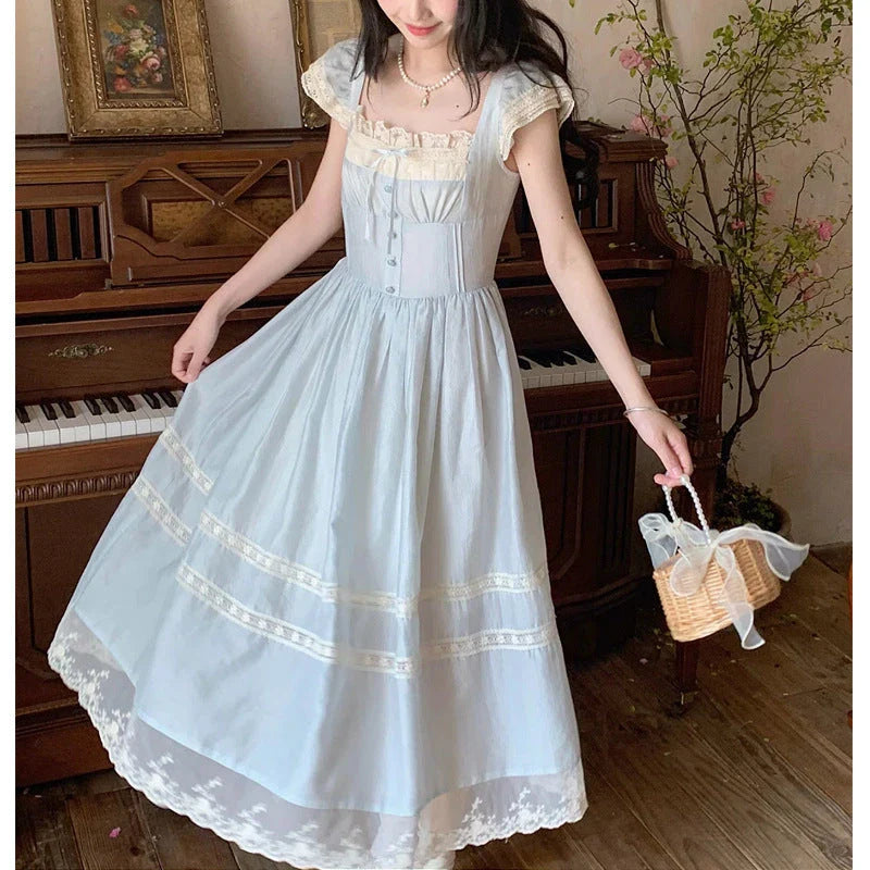 Elegant lace-trimmed blue maxi dress with high-waisted silhouette and sleeveless design