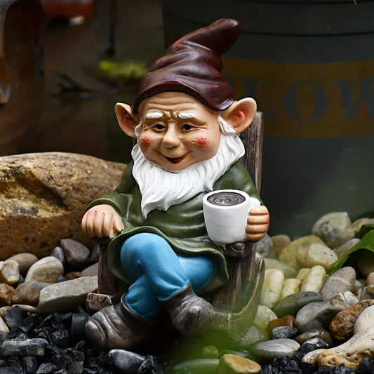 A charming garden gnome ornament made of durable resin, relaxing in a rocking chair and sipping tea, adding a whimsical touch to any outdoor space.