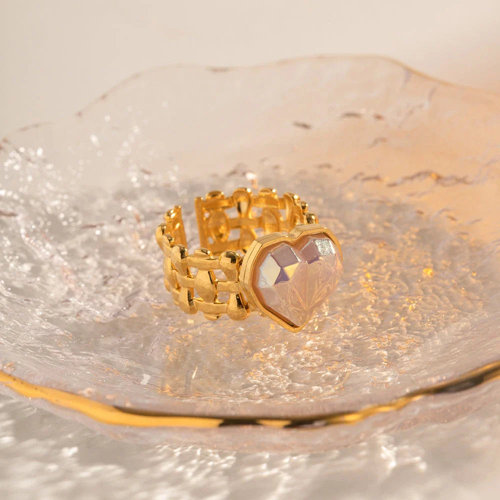 Adjustable stainless steel ring with a mermaid-inspired heart design and shell beads, a unique and versatile accessory.