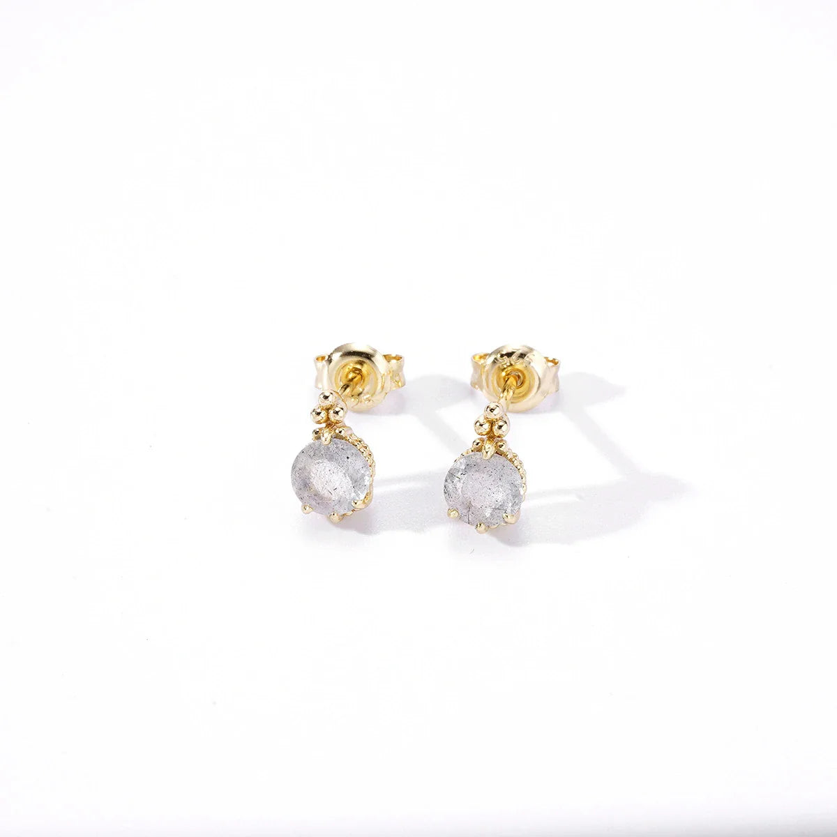 Elegant elongated stone earrings with a geometric design and a white crystal, a sophisticated accessory for the discerning British woman.