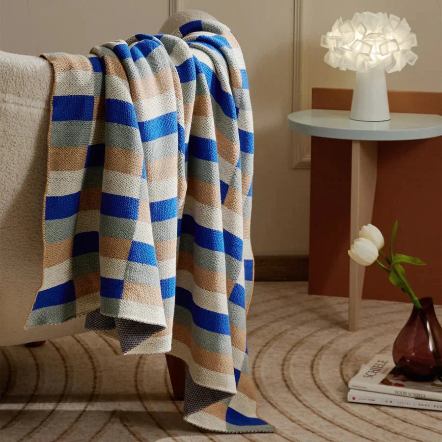 Cosy 100% cotton striped plaid throw blanket in vibrant orange and blue hues, perfect for adding rustic charm to any living space.