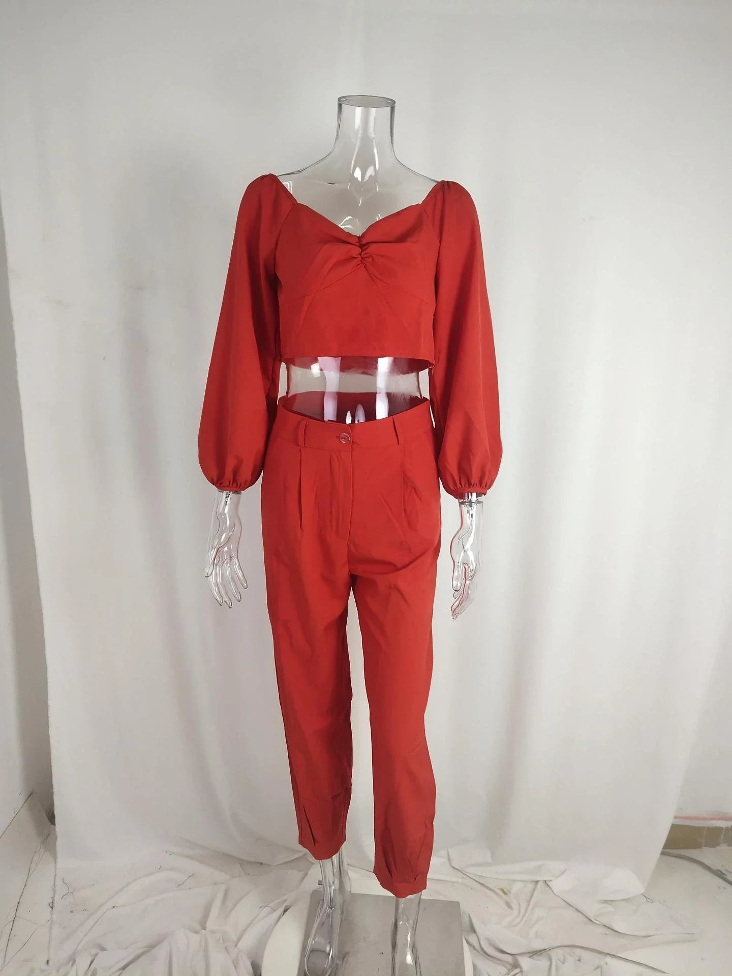 A stylish two-piece set with a square neckline top and ankle-tie trousers, made of premium polyester fabric and available in a range of vibrant solid colours.