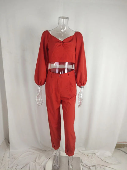 A stylish two-piece set with a square neckline top and ankle-tie trousers, made of premium polyester fabric and available in a range of vibrant solid colours.