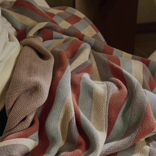 Cosy 100% cotton striped plaid throw blanket in vibrant orange and blue hues, perfect for adding rustic charm to any living space.