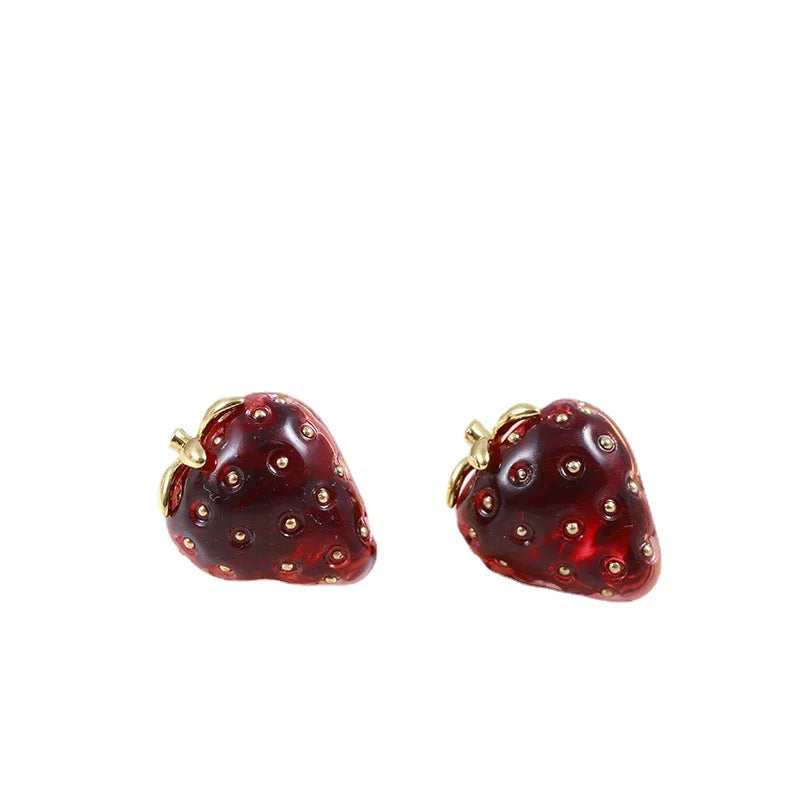 Pair of red resin strawberry stud earrings with a three-dimensional design and secure backing