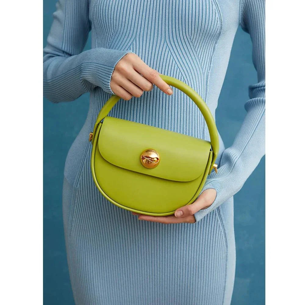 Exquisite red leather round handbag with ball-inlaid hardware, a chic and versatile accessory for UK fashion enthusiasts