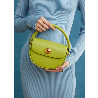 Exquisite red leather round handbag with ball-inlaid hardware, a chic and versatile accessory for UK fashion enthusiasts