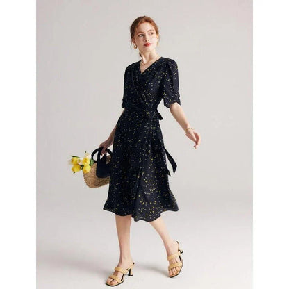 Elegant black polka dot silk wrap dress with V-neck and empire waistline, perfect for formal and casual occasions