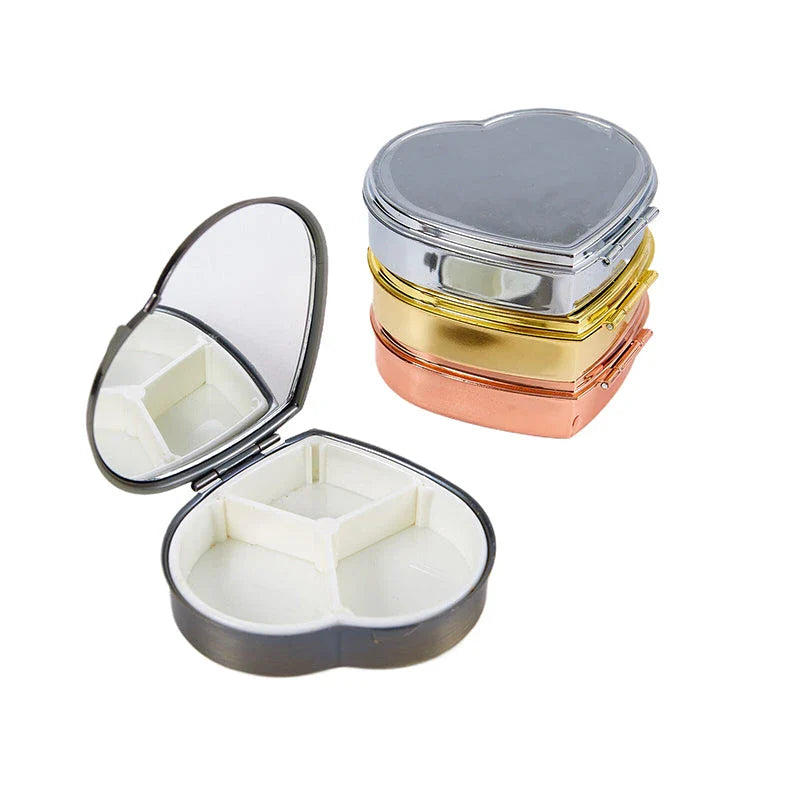Heart-shaped metal pill box with built-in mirror for convenient storage and touch-ups on the go