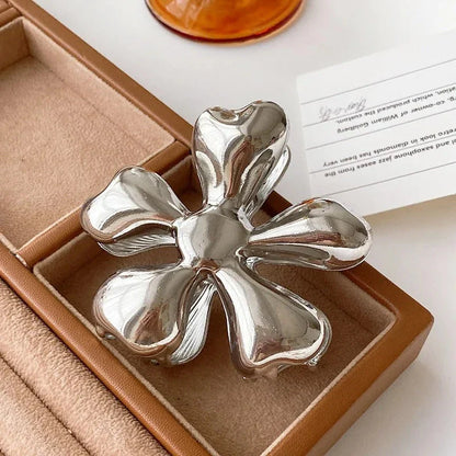 Gold floral metal hair claws - chic hair accessories for women with modern design and natural elegance