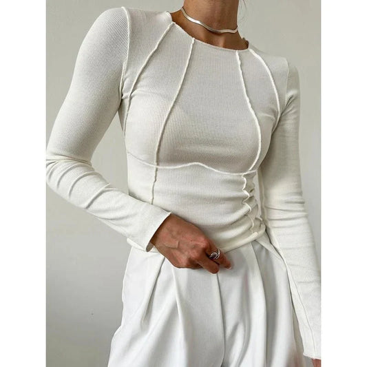 A model wearing a comfortable and stylish long sleeve t-shirt in a solid white colour.