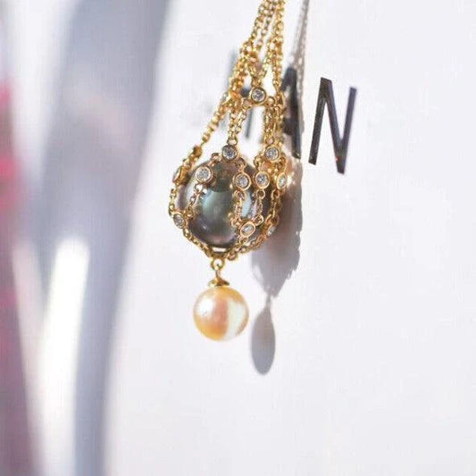 Elegant shell bead necklace with 18K gold plating and a delicate net crystal pendant