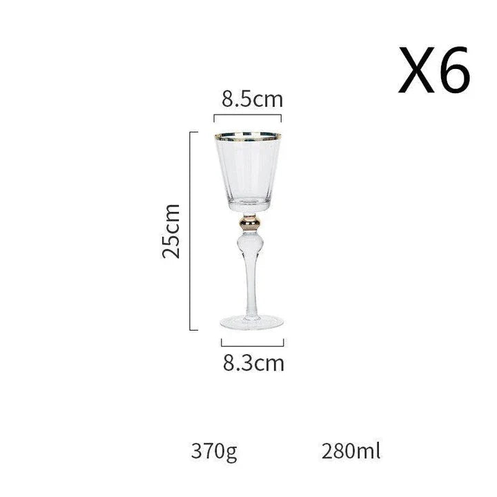 Elegant crystal wine glasses with refined gold vertical patterns, perfect for enjoying fine wines and champagne