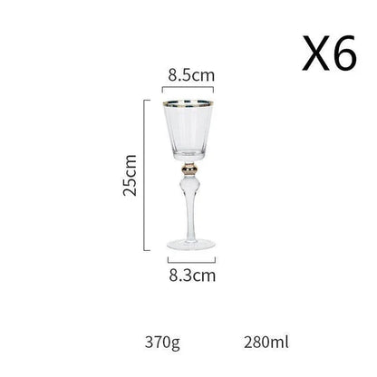 Elegant crystal wine glasses with refined gold vertical patterns, perfect for enjoying fine wines and champagne