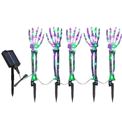 Solar-powered Halloween ground lamp with hand-shaped LED lights in purple and green colours, creating a spooky ambience in an outdoor courtyard