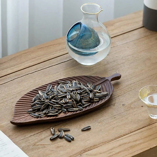 Elegant leaf-shaped serving platter made of solid oak wood, featuring a natural and stylish design for hosting and entertaining