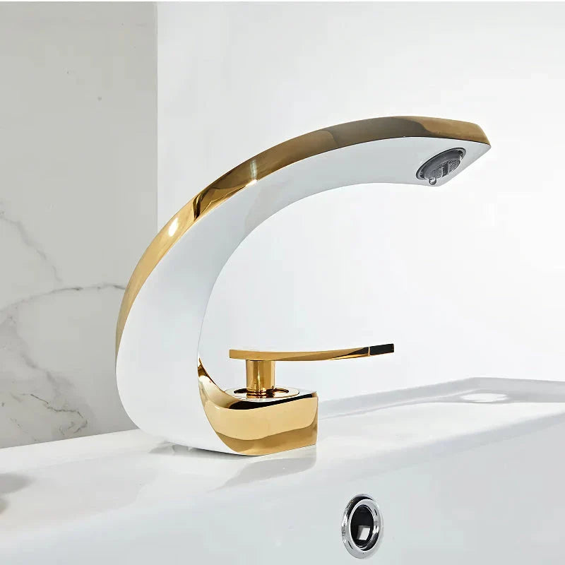 Elegant brass gold and white bathroom basin faucet with sleek, contemporary design