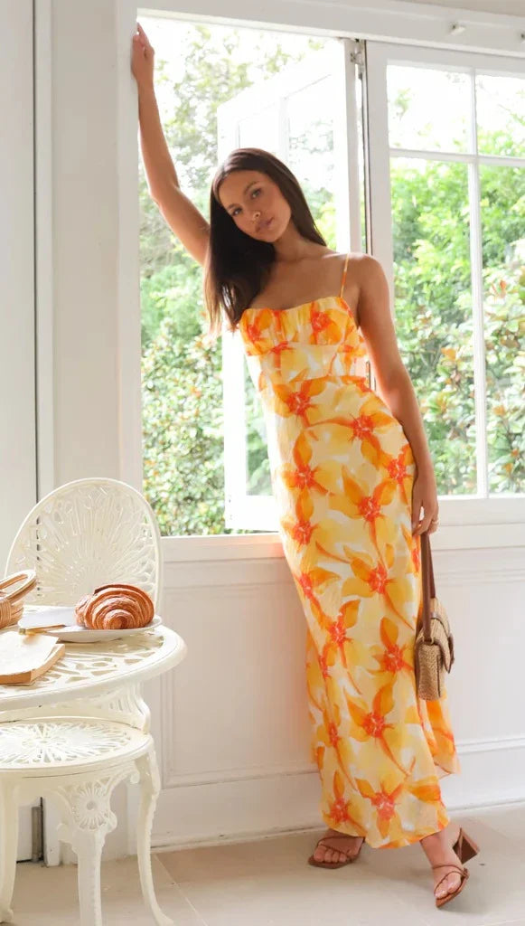 Elegant floral midi dress with backless design, available in yellow, purple, and green colours
