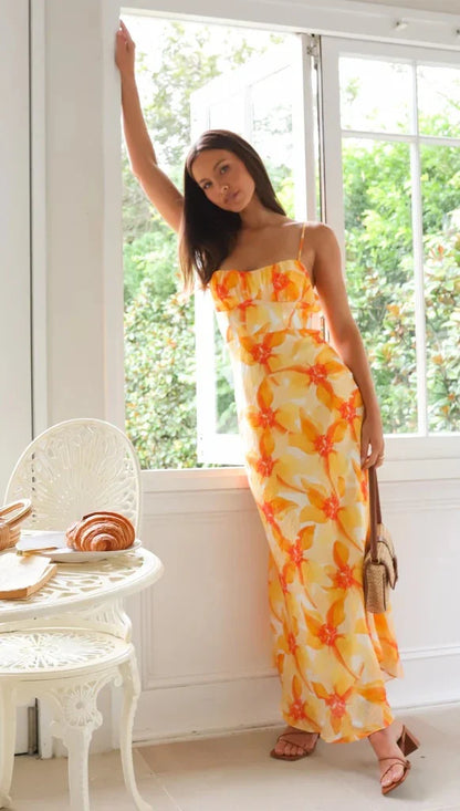 Elegant floral midi dress with backless design, available in yellow, purple, and green colours