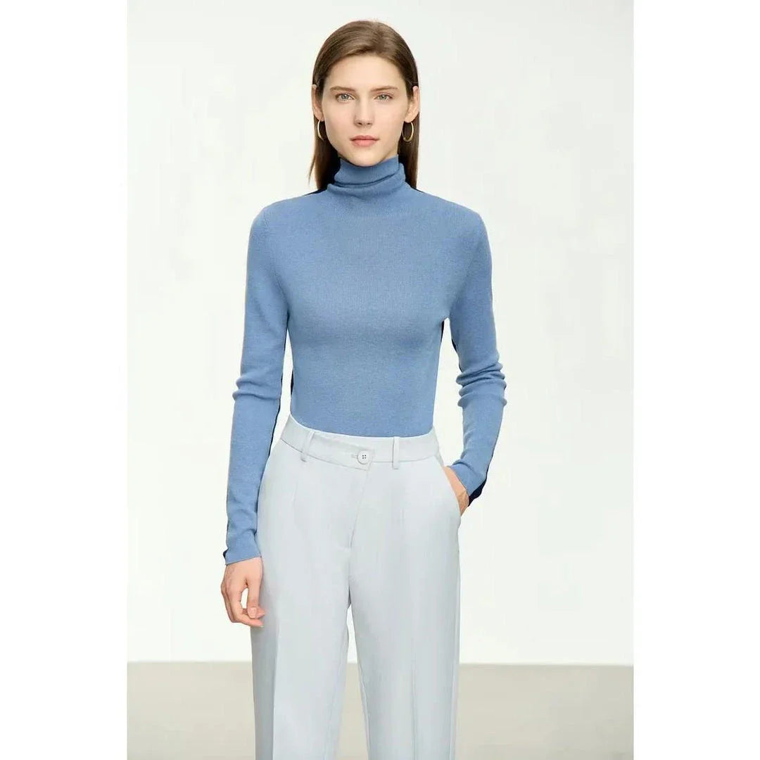 A cosy and stylish turtleneck sweater with a unique patchwork design, made from a premium wool blend for exceptional comfort and elegance.
