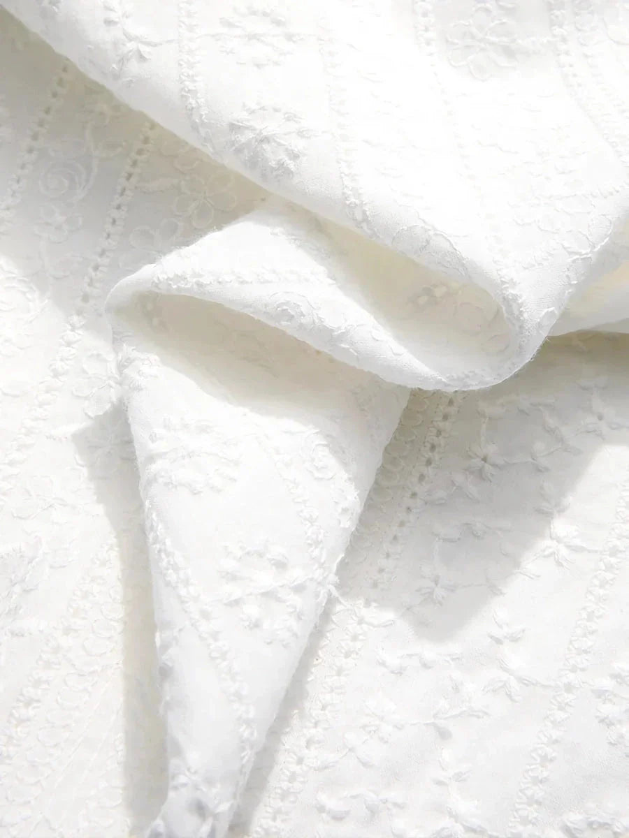 Elegant British-inspired white cotton puff sleeve blouse with a tailored regular fit and feminine flair